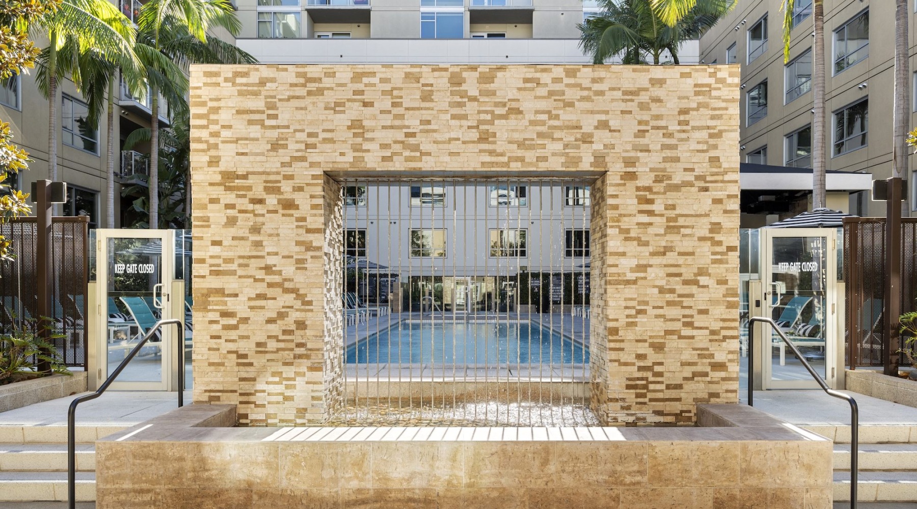 a brick archway with a waterfall