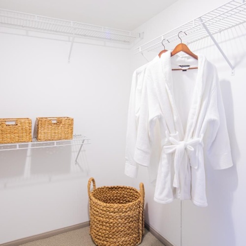 a white room with white clothes on a swinger